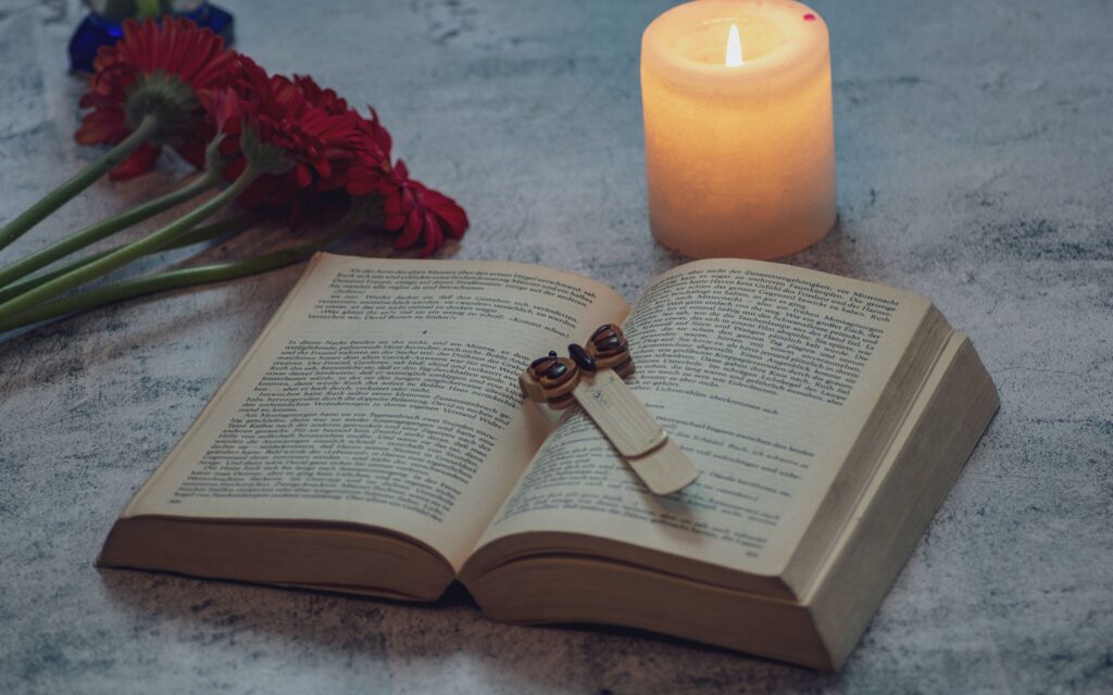 an open book with a candle