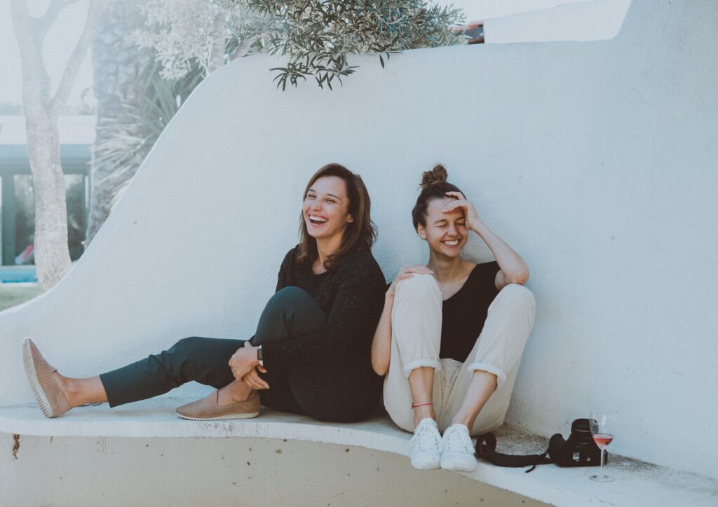 two friends laughing on the ground